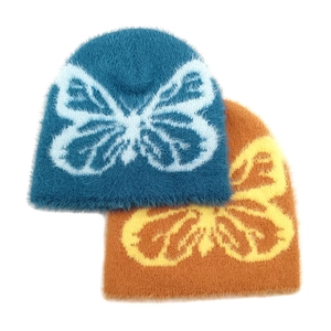 Plush butterfly pattern knit beanies in peacock blue and caramel for winter warmth