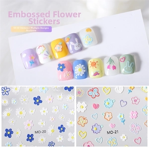 Detailed macro view of 5D embossed nail art stickers featuring 3D floral and rabbit patterns