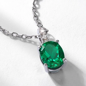 Oval cut emerald pendant in S925 sterling silver with sparkling zircon accents on white