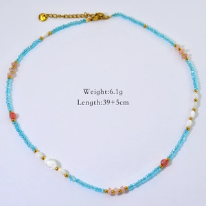 Detail view of handmade beaded necklace with natural blue, pink beads and golden clasp