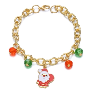 Golden Christmas bracelet with Santa Claus charm and red green crystals on white background
