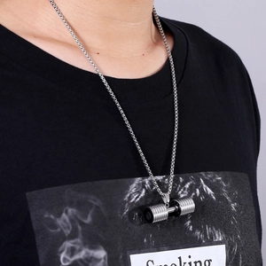 Polished silver stainless steel dumbbell necklace for fitness on a model with black t-shirt