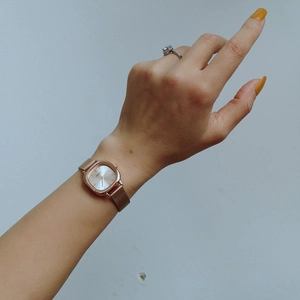 NAIDU square rose gold quartz watch with mesh strap displayed on a female wrist