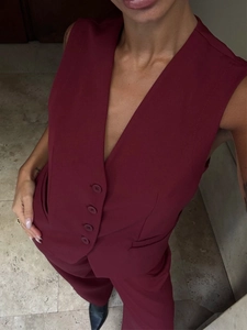 Detail view of burgundy two-piece vest and straight trousers suit from a top-down angle