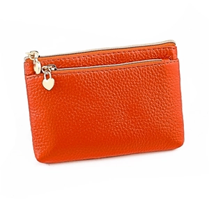 Close-up of orange genuine leather coin purse with double zippers and heart puller