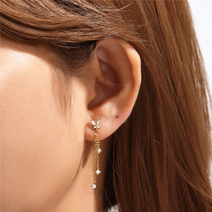 Detail of S925 silver golden butterfly earring with sparkling tassel chain on model