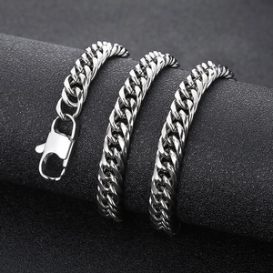 Detailed close-up of polished silver Cuban link chain with lobster clasp and metal gloss