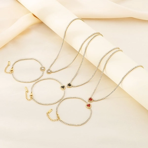 Golden tennis jewelry set featuring necklaces and bracelets with white black and red heart zircon