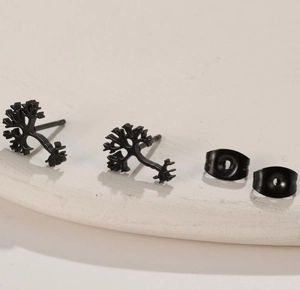 Detail of matte black Tree of Life stud earrings with branch structure on white display