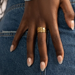 Elegant gold titanium steel ring with an irregular wavy design worn on the finger