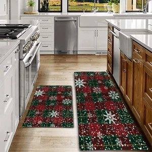 Detail of red and green plaid Christmas kitchen floor mats with snowflake patterns
