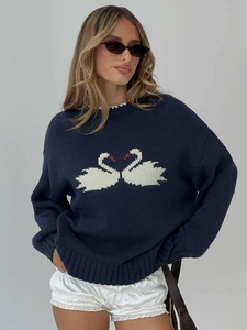 Navy blue loose knit sweater featuring white swan jacquard pattern and ribbed cuffs