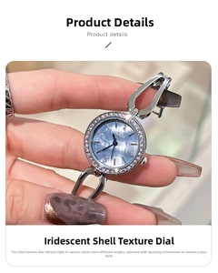 Detailed macro view of woman's quartz watch with rhinestone bezel and shell texture dial