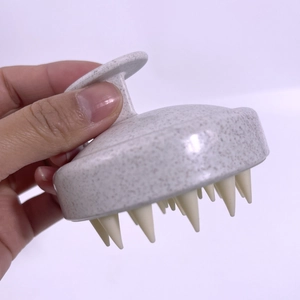 Close-up of wheat straw hair scalp massager brush with flexible white silicone bristles