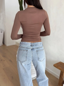 Rear view of brown slim-fit long-sleeve T-shirt highlighting tight Y2K elastic fabric fit