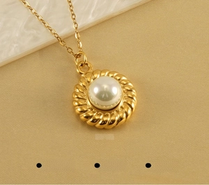 Macro view of 18k gold plated stainless steel necklace with white pearl pendant