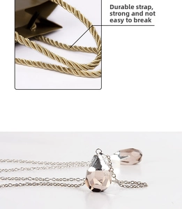 Detail view of reinforced rope handles on a gift bag with a teardrop crystal necklace