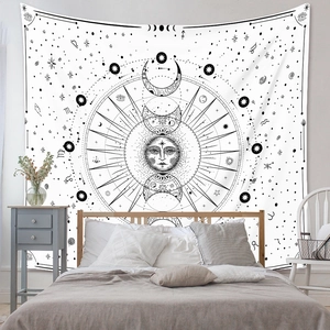 Detail of bohemian tapestry featuring sun, moon phases and zodiac signs in a bedroom setting