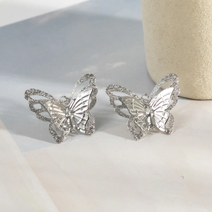 Elegant silver butterfly stud earrings with hollow-carved double layers for women