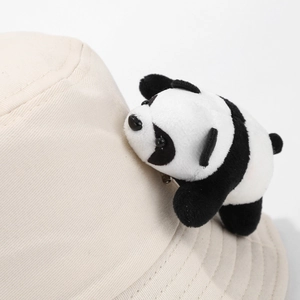 Close-up of beige cotton sun hat with a cute 3D panda plush and detailed stitching