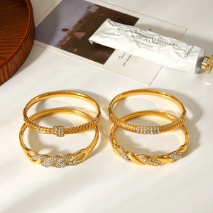Macro shot of 18k gold plated stainless steel bracelets with diamonds in a luxury setup