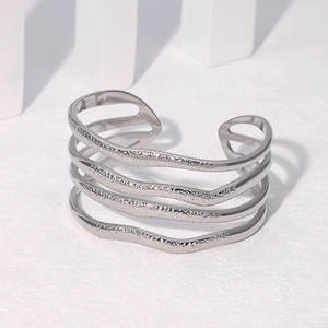 Detail of silver multi-layer open cuff bracelet with irregular hammered metal textures
