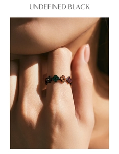 Detailed close-up of a vintage S925 silver ring featuring colorful clover patterns and gems