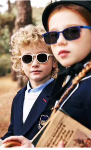 Detail of round cream and rectangular blue kids sunglasses with UV protection lenses