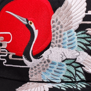 Black baseball cap featuring high-density crane and red sun embroidery details
