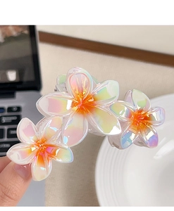 Detail of gradient plumeria hair claw clip with pearlescent resin finish and metal spring