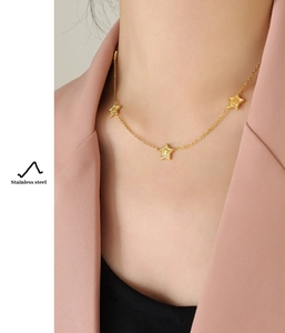 Detail of star pendant necklace with zircons on model neck in 18K gold plated steel
