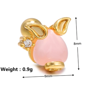 Macro shot of 8mm pink pig stud earring with white zircon and gold metal outlines