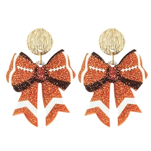 Close-up of glitter football bow earrings with orange and brown sequin details