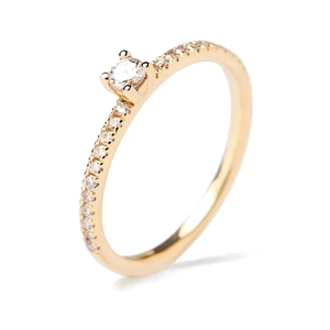 Detailed close-up of a gold S925 sterling silver ring with a four-prong set sparkling gem
