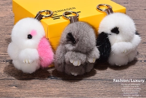 Three fluffy mink fur rabbit charms in pink, grey and black with gold keychains