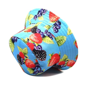Detail of light blue bucket hat featuring vibrant strawberry and blueberry fruit prints