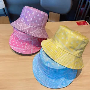 Detailed pile of four colorful paisley bucket hats in pink, yellow, blue, and purple hues