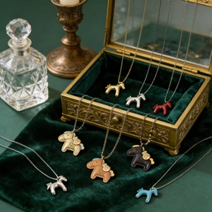 Vintage horse pendant necklaces in various colors displayed in an ornate gold jewelry box