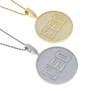 Detailed view of CEO shield pendants in gold and silver finish with AAA cubic zirconia