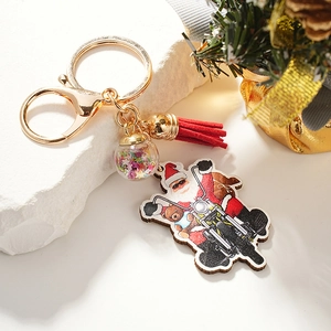 Christmas keychain with Santa Claus on motorcycle, red tassel and sparkling ball charm