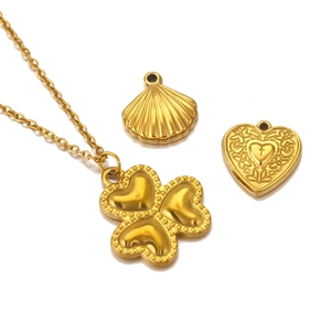 Gold stainless steel jewelry set featuring clover necklace, heart and shell pendants