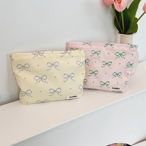 Close-up of floral makeup bags with bow patterns in soft cotton linen fabric