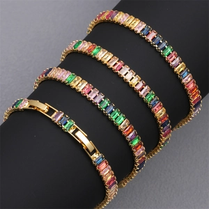 Macro detail of 18K gold plated tennis bracelets with multi-colored baguette crystals