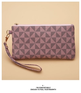 Detail of pink and black geometric pattern on women clutch with gold zipper and wrist strap