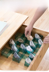 Detail of transparent green drawer dividers in PS material for sock organization