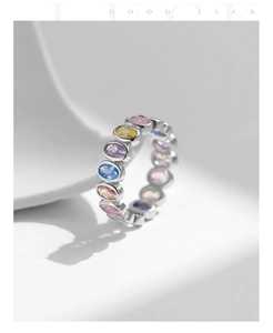 Close-up of S925 silver eternity ring with colorful oval-cut cubic zirconia stones