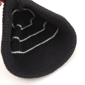 Black and white striped knit beanie hat with thermal ribbed texture for autumn and winter