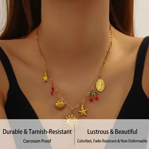 Close-up of golden stainless steel necklace with sun starfish and cross charms on model