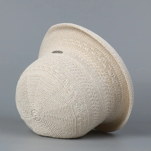 Chic cream knit bucket hat with rolled edge and silver logo for summer sun protection