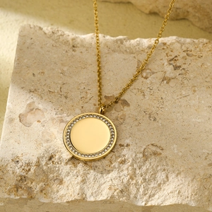 Luxe gold-tone stainless steel necklace featuring a circle pendant with pavé-set crystals